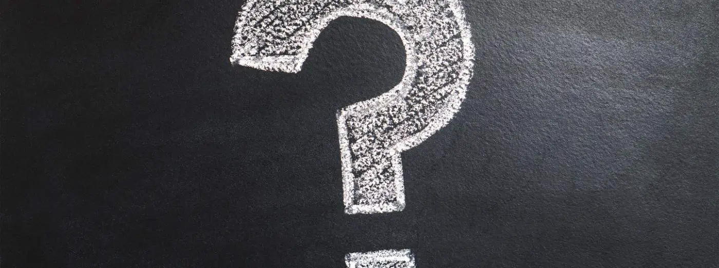 White chalk image of a question mark on a blackboard