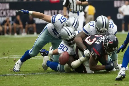Houstan Texans and Dallas Cowboys football fumble
