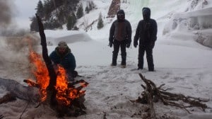 Warming up at the bonfire during an ice climb