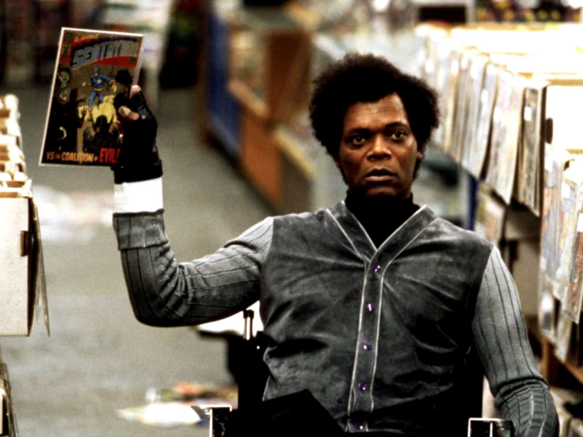 Samuel L. Jackson as Mr. Glass in Unbreakable holding Sentryman comic book