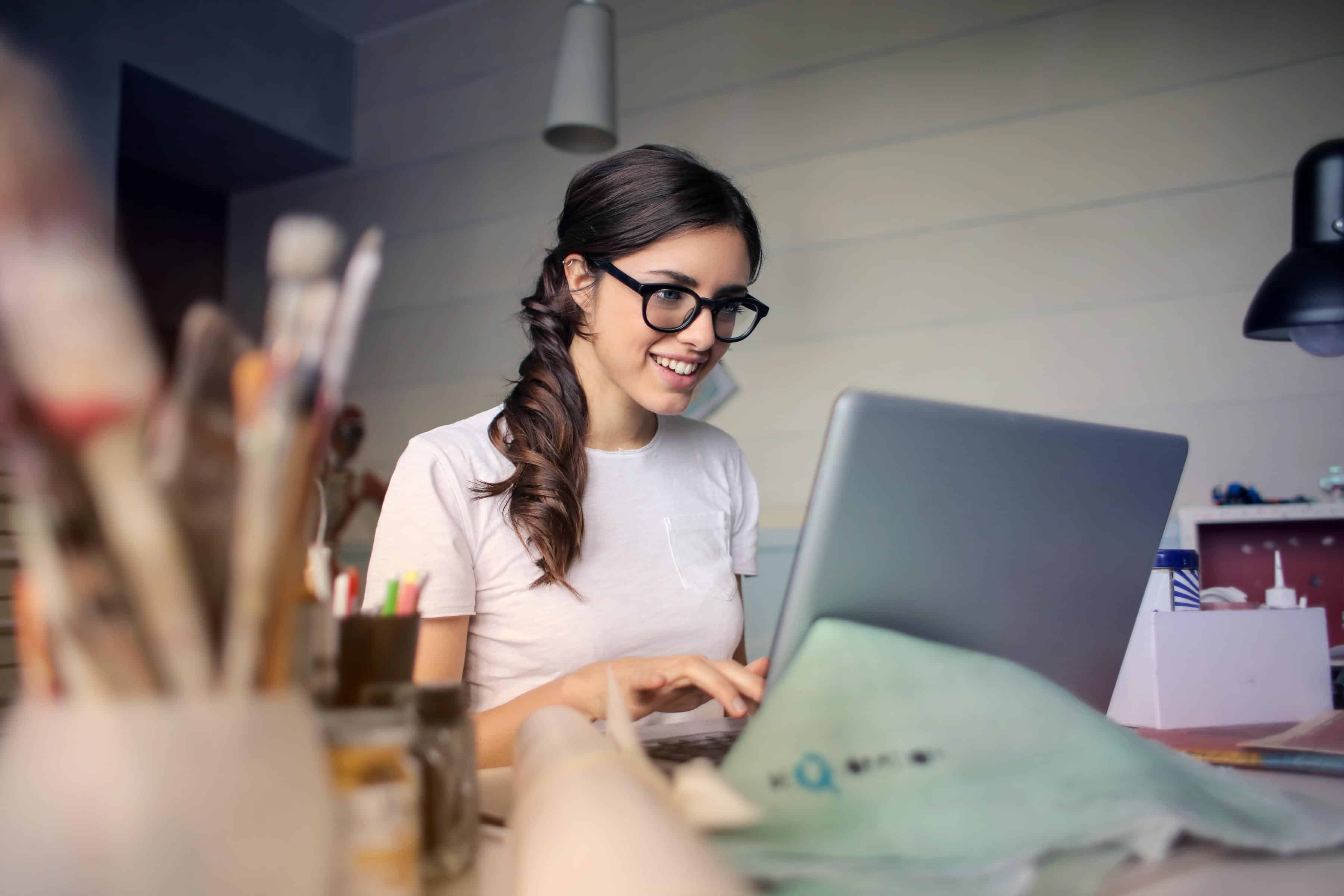 Woman working on a silver laptop