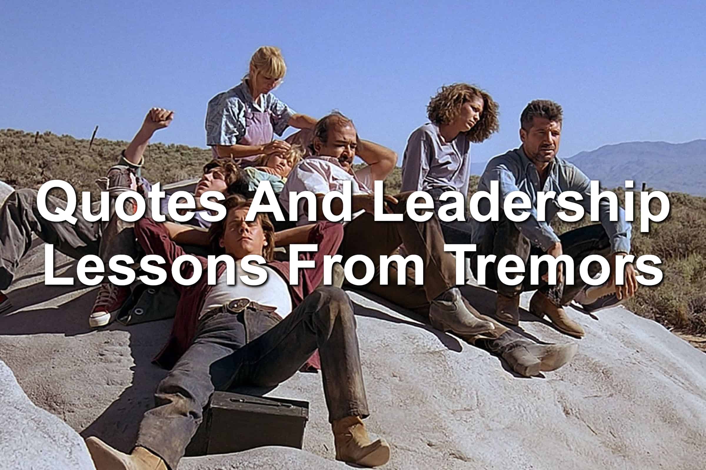 Cast of the original Tremors movie sitting on a rock