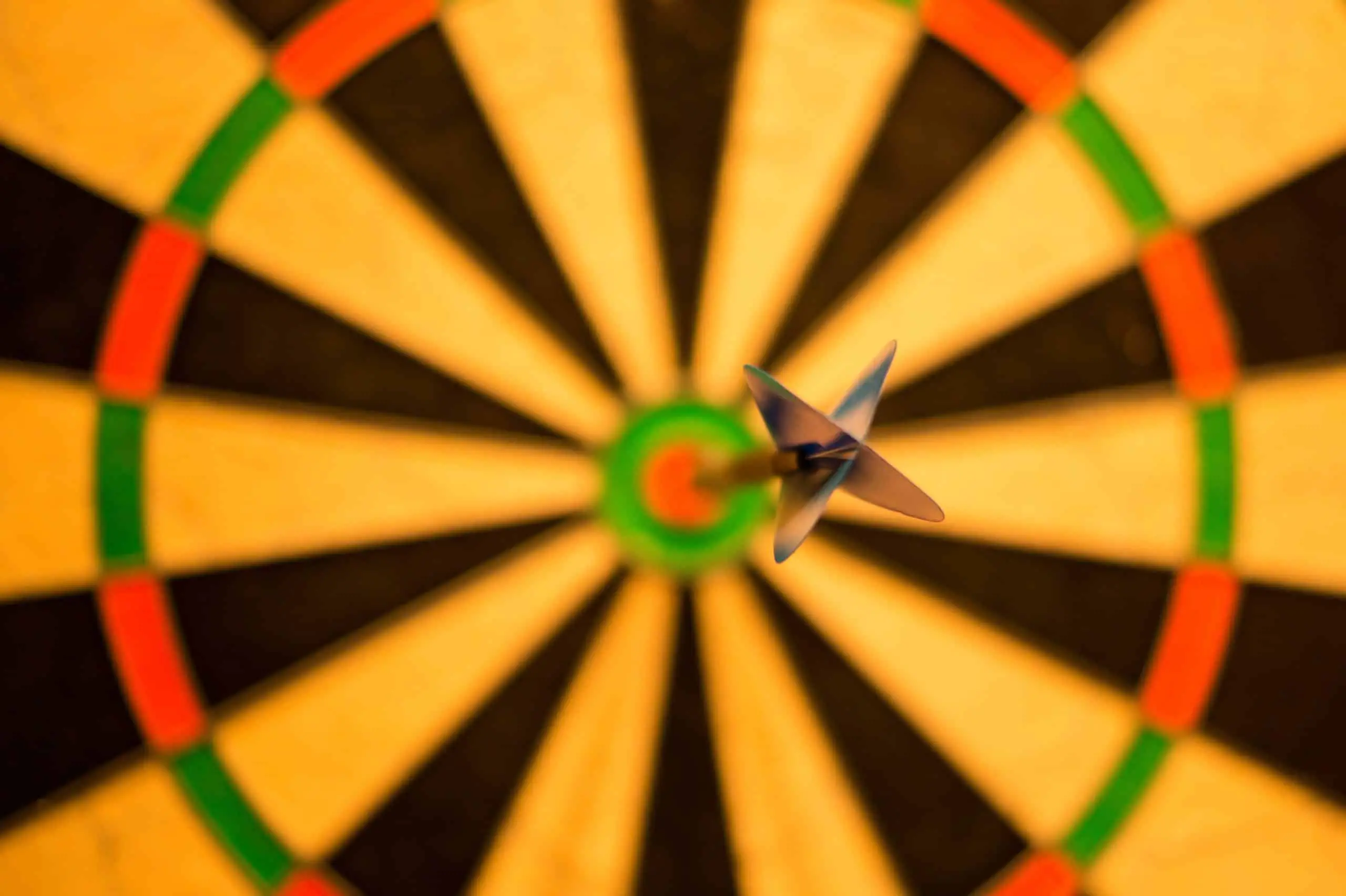 Dartboard with a dart in the bullseye