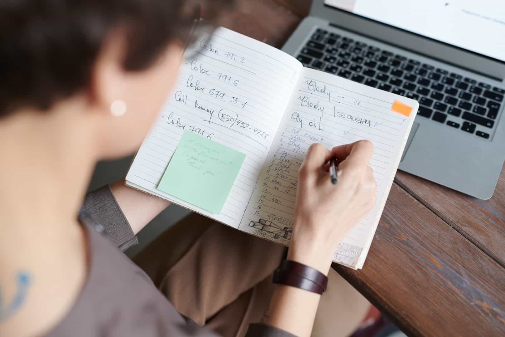 Woman writing in a calendar journal