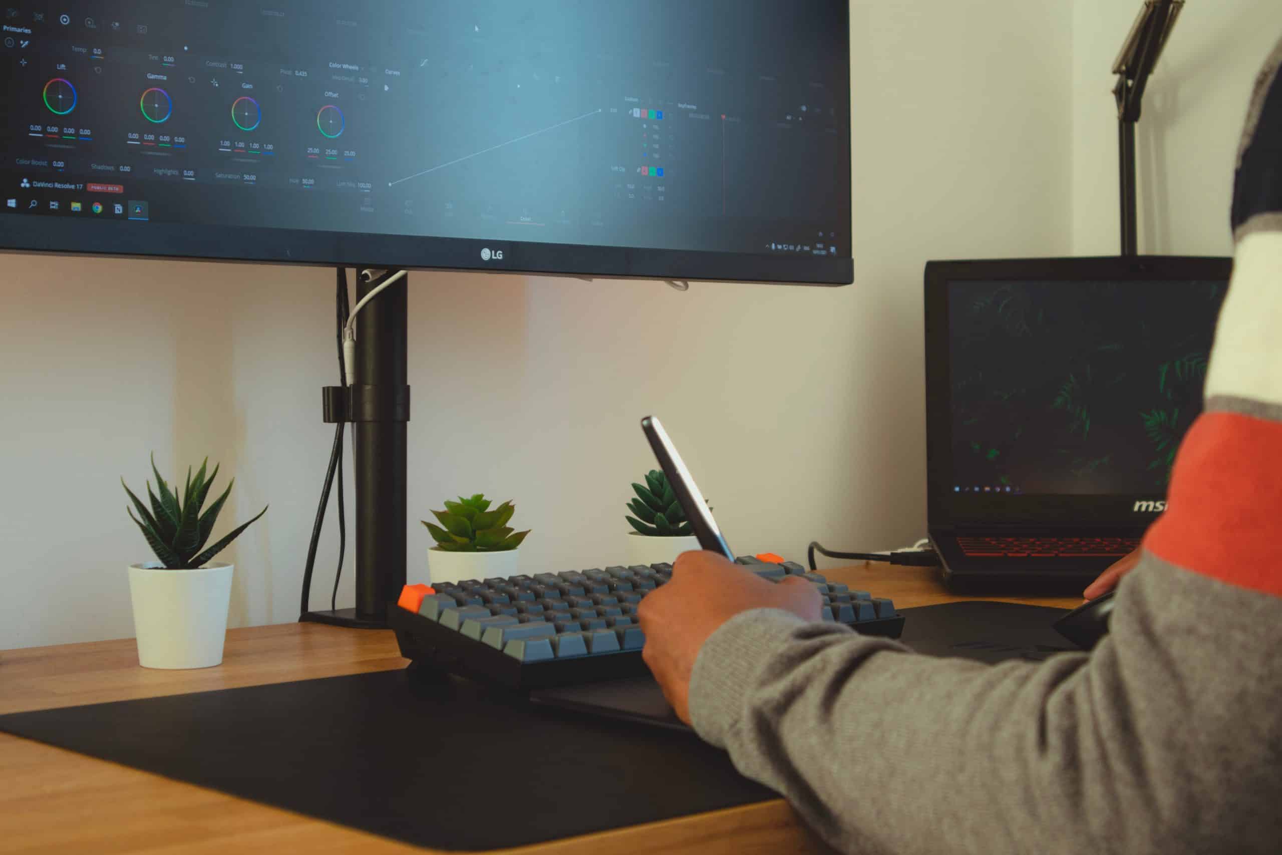 Hand in front of a computer screen