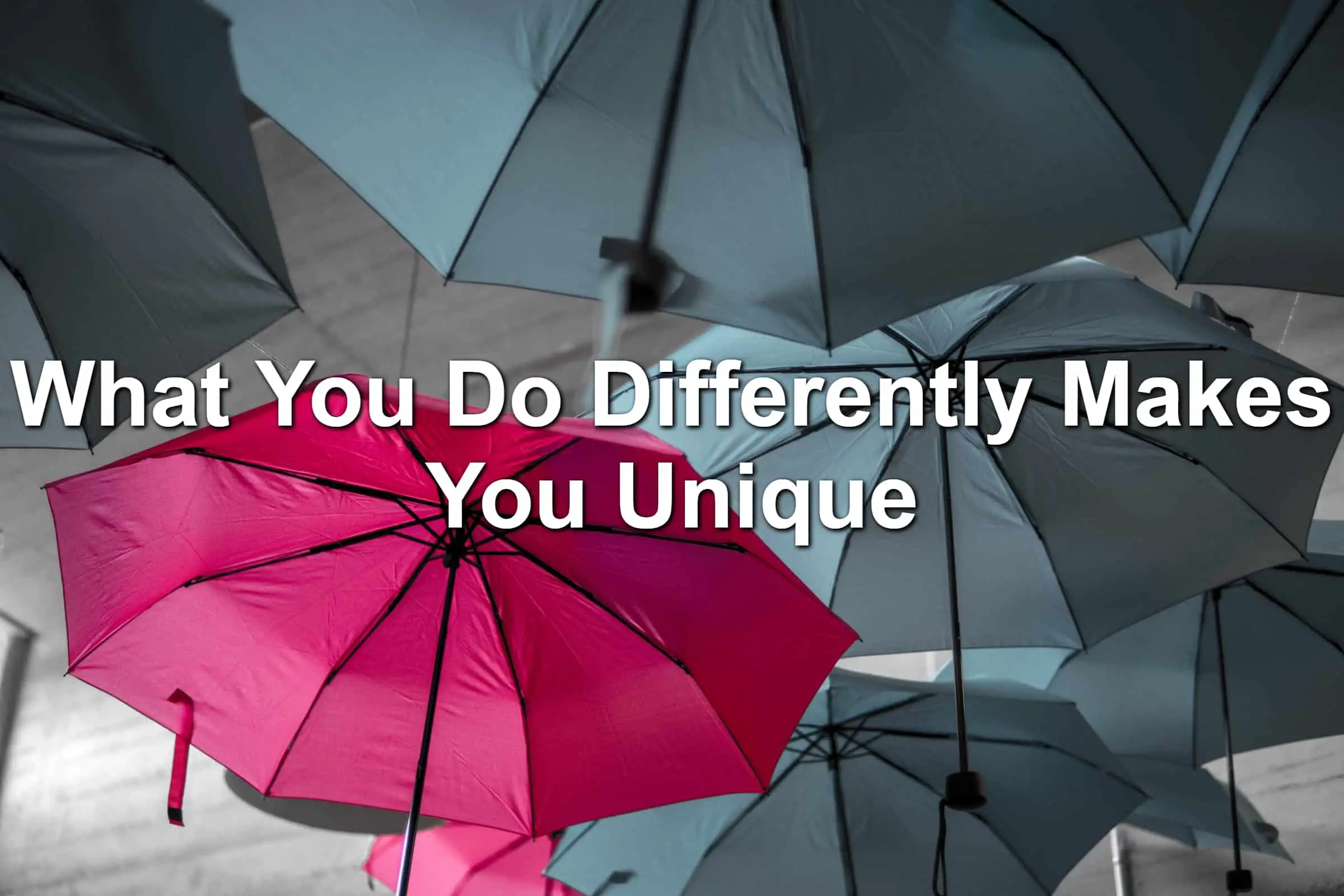 Colorful umbrella in the midst of gray umbrellas