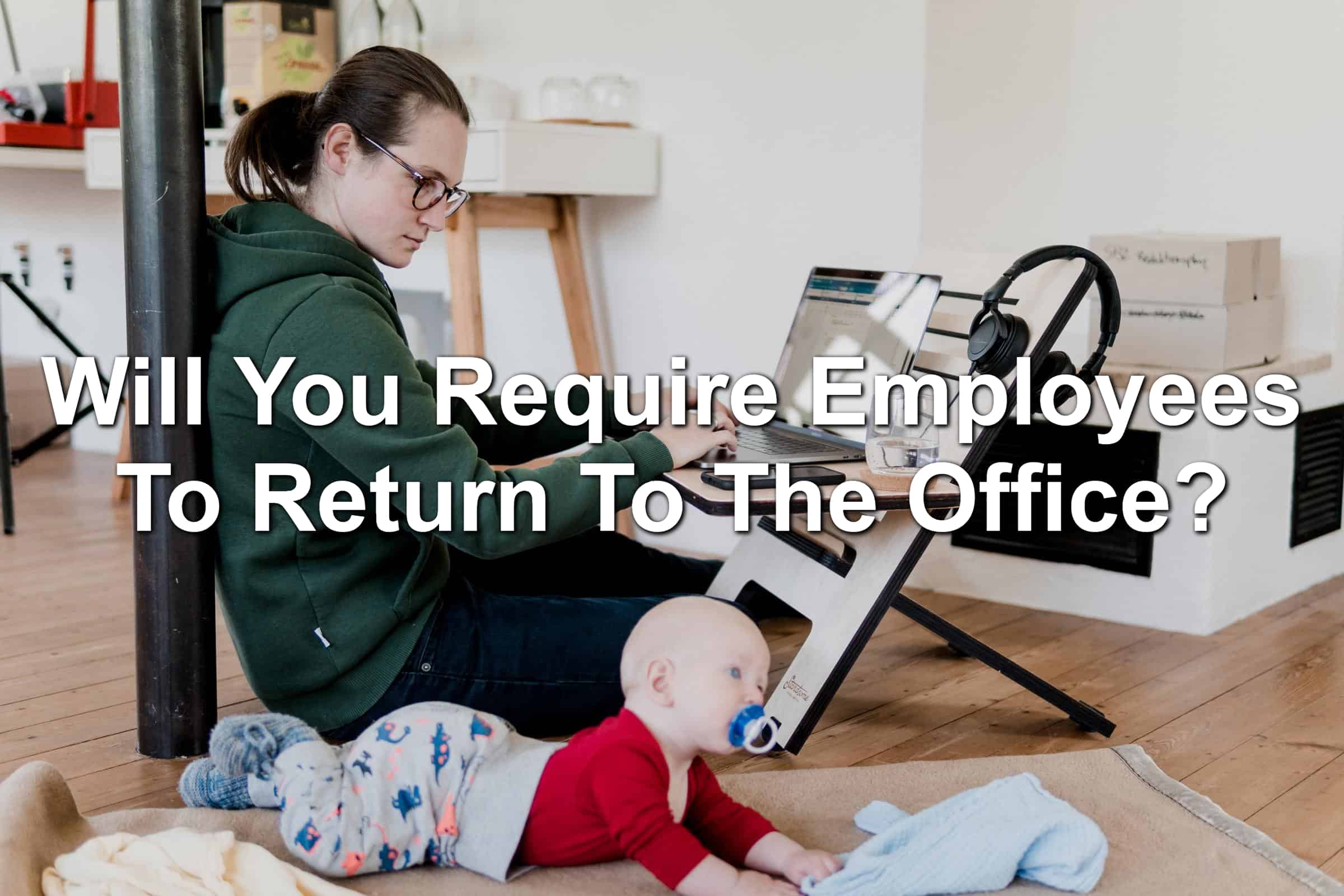 Woman working from home with a baby in the foreground.