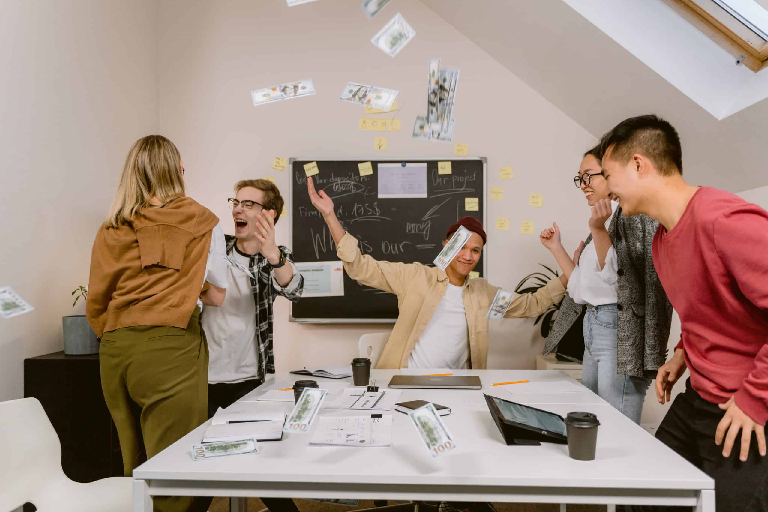 Team celebrating in front of board