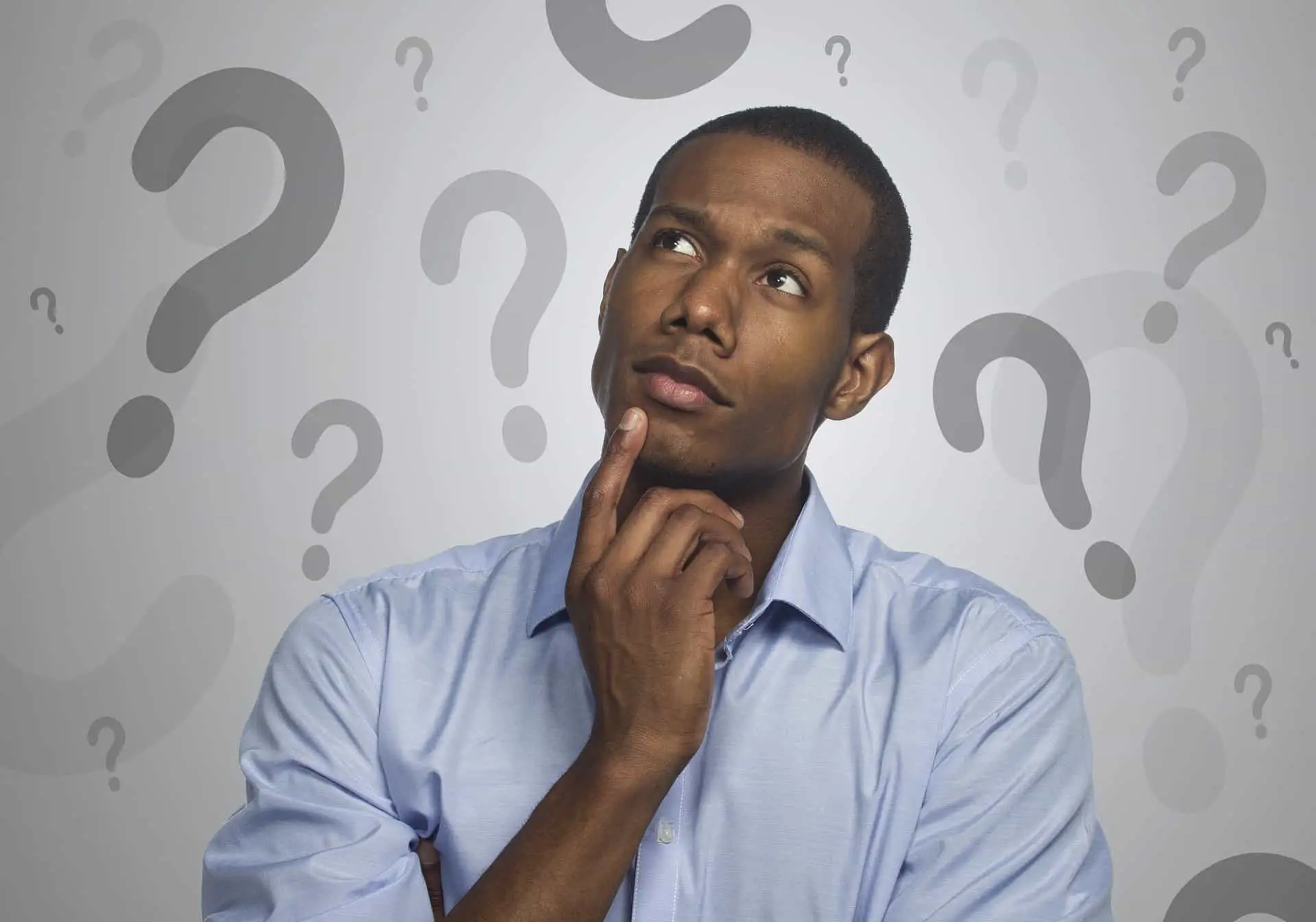 African American man thinking with question marks behind him