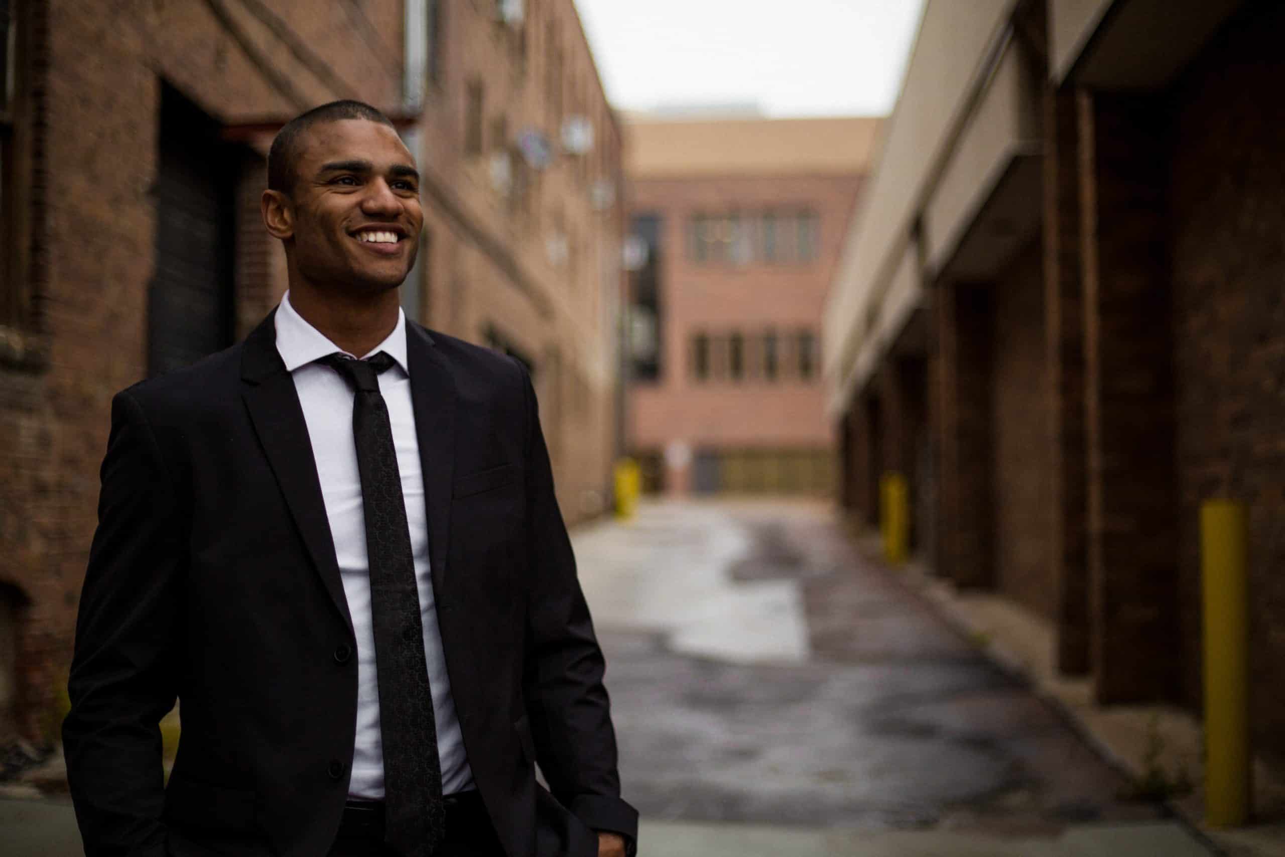 Man smiling in an alley