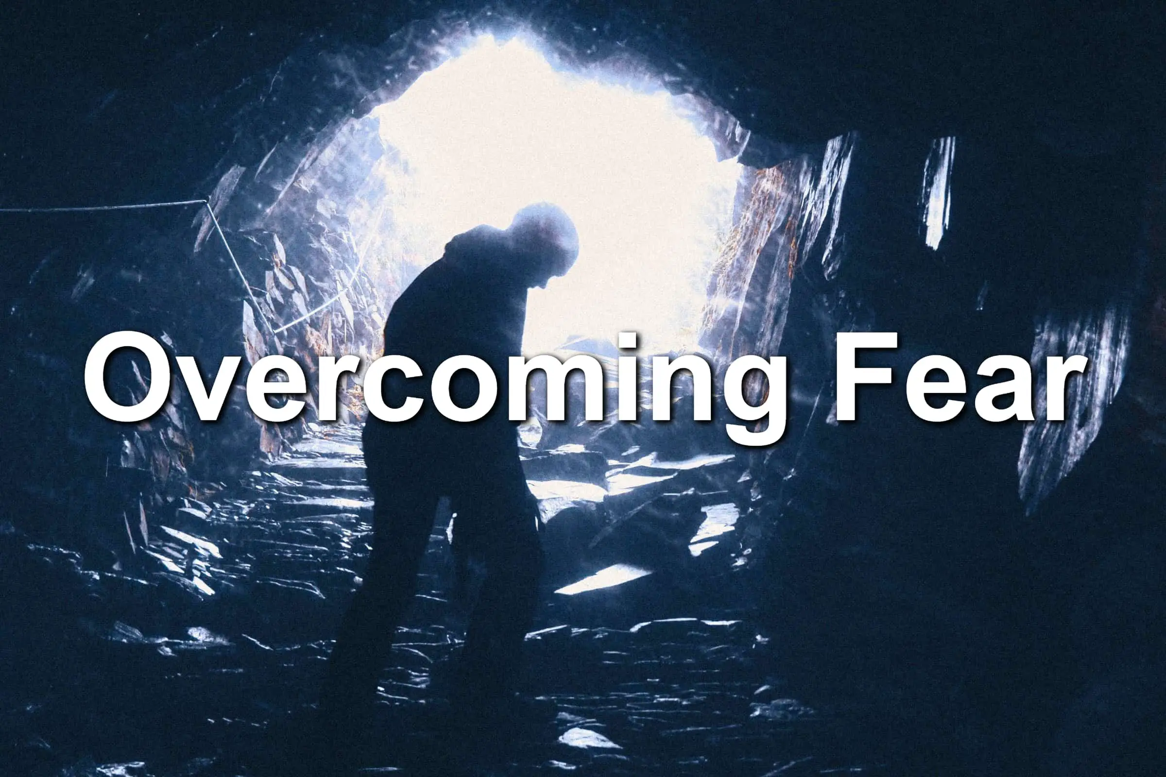 Man exciting a fearful looking cave while overcoming fear