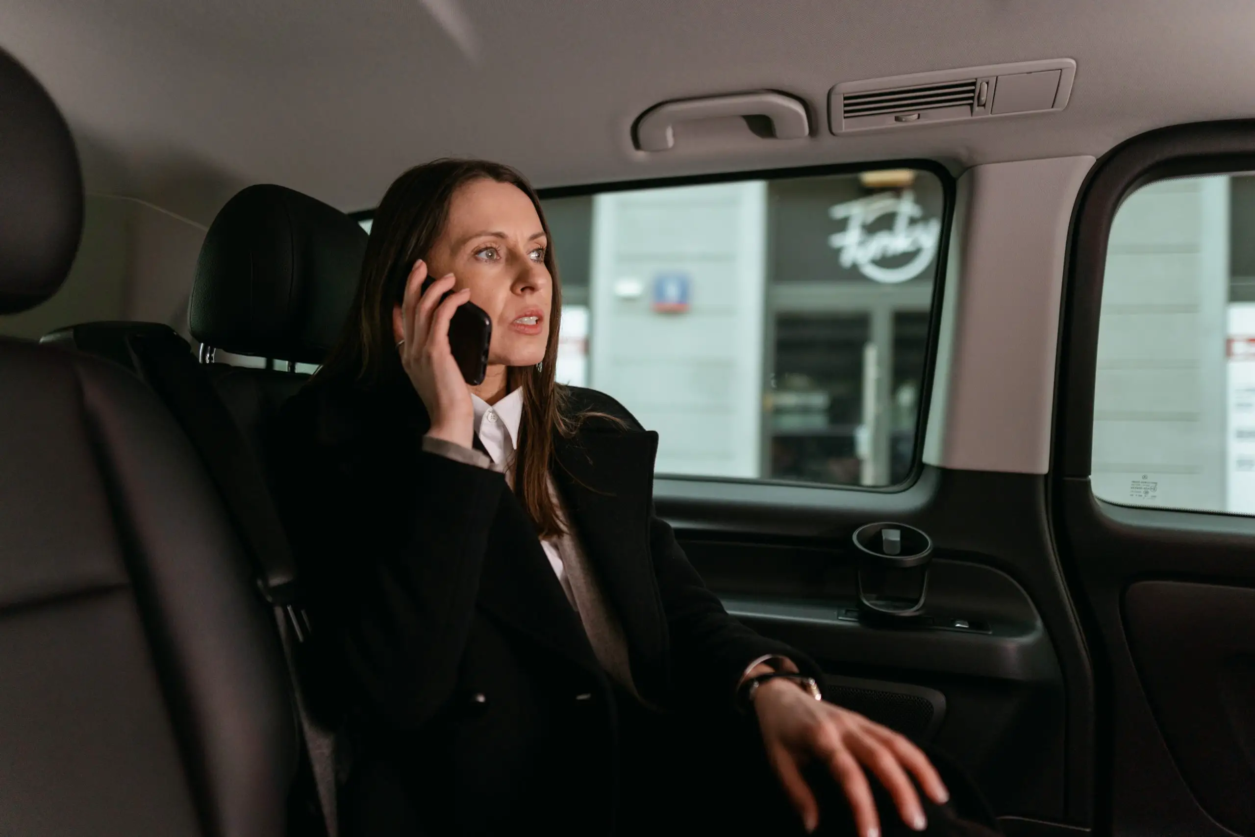 Woman in a car on a cell phone