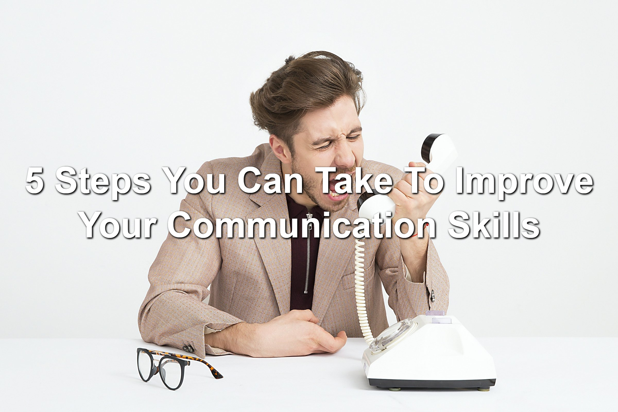 Man yelling into corded phone