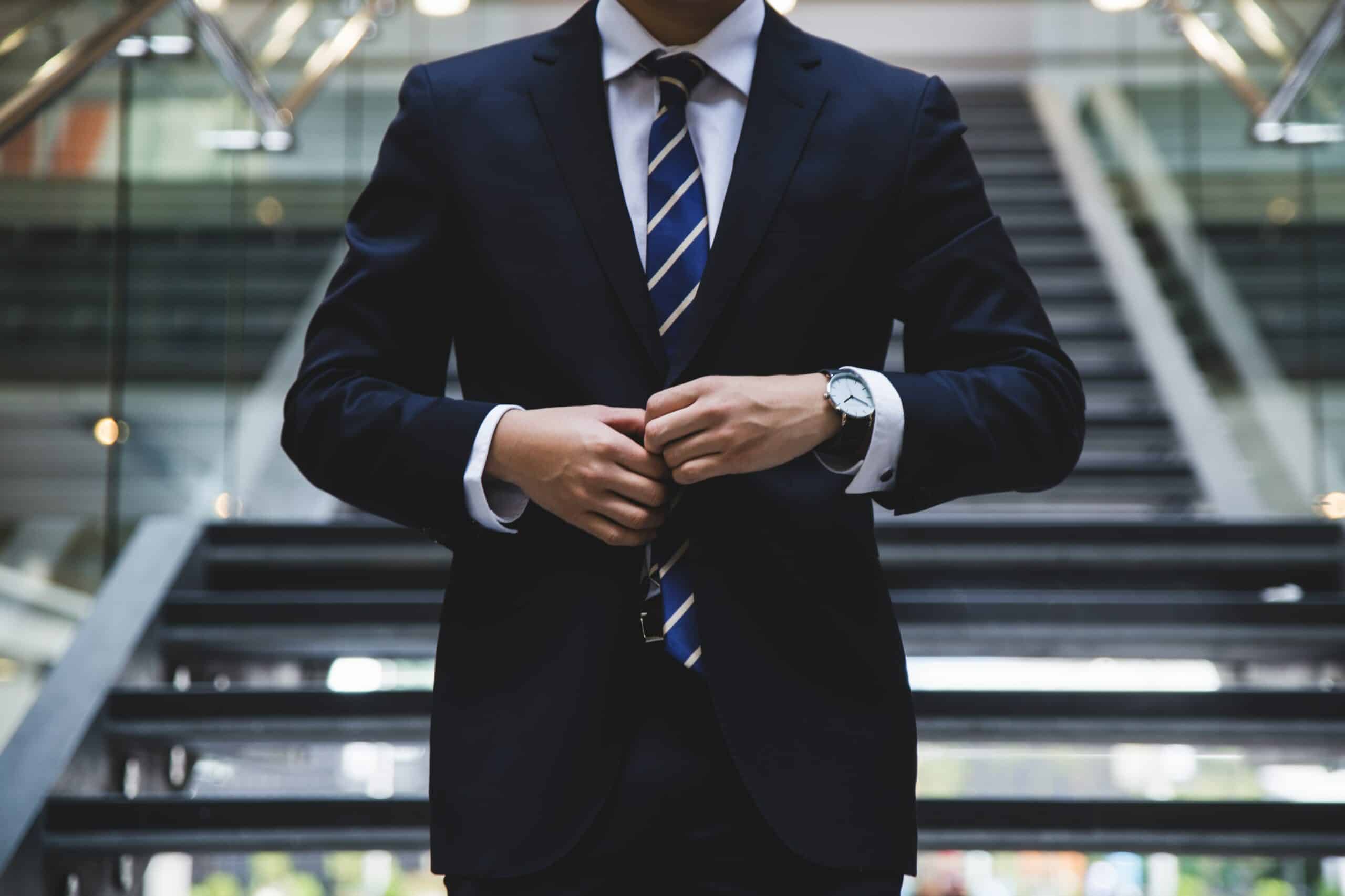 Man in a business suit with his hands pressed together