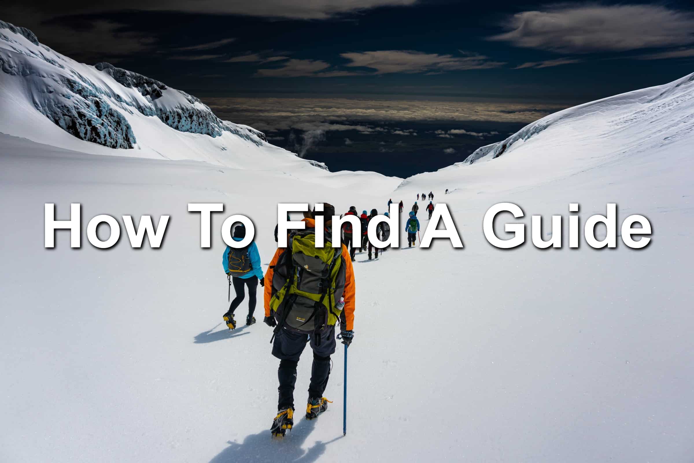 People being guided through a snowy mountain path