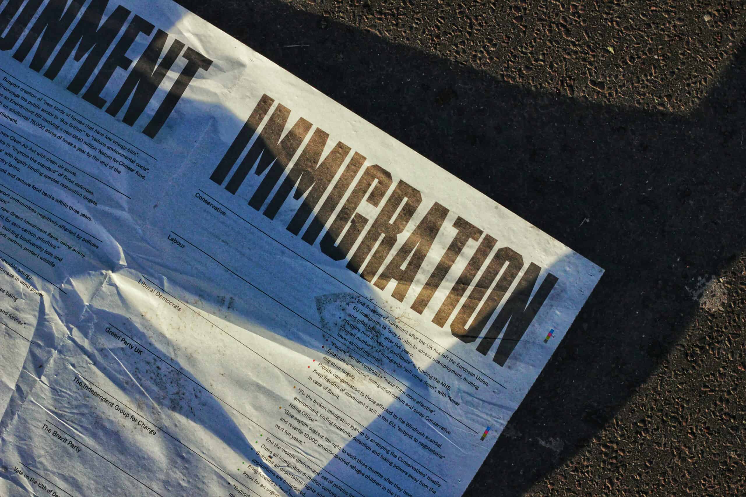 Paper with the text IMMIGRATION typed on it