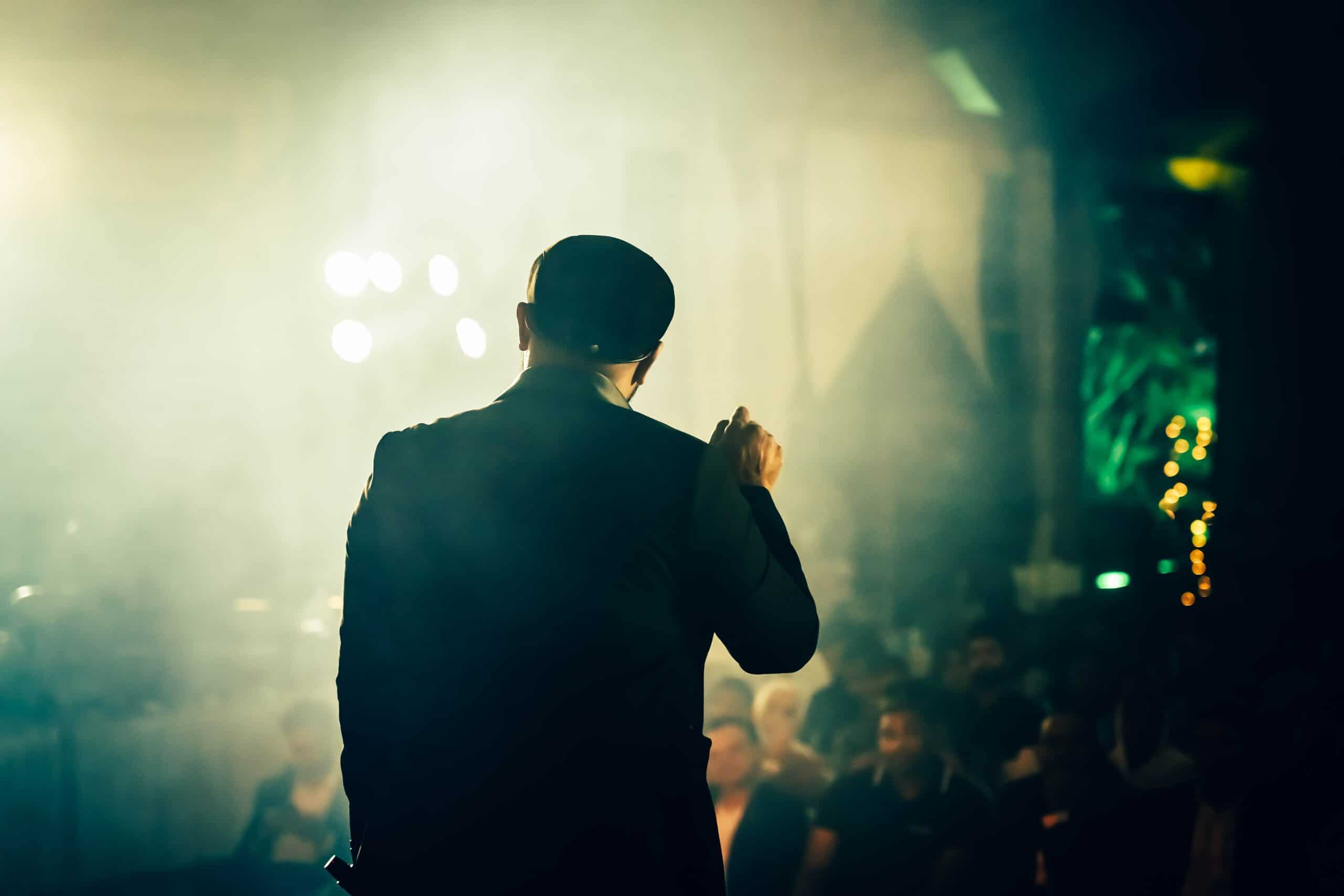 Man speaking to a crowd. Finger pointing toward them.