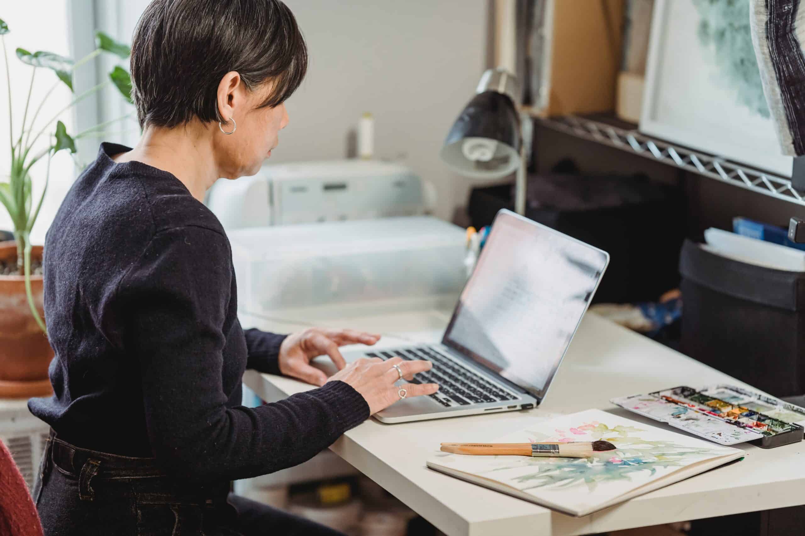 Woman typing on a laptop