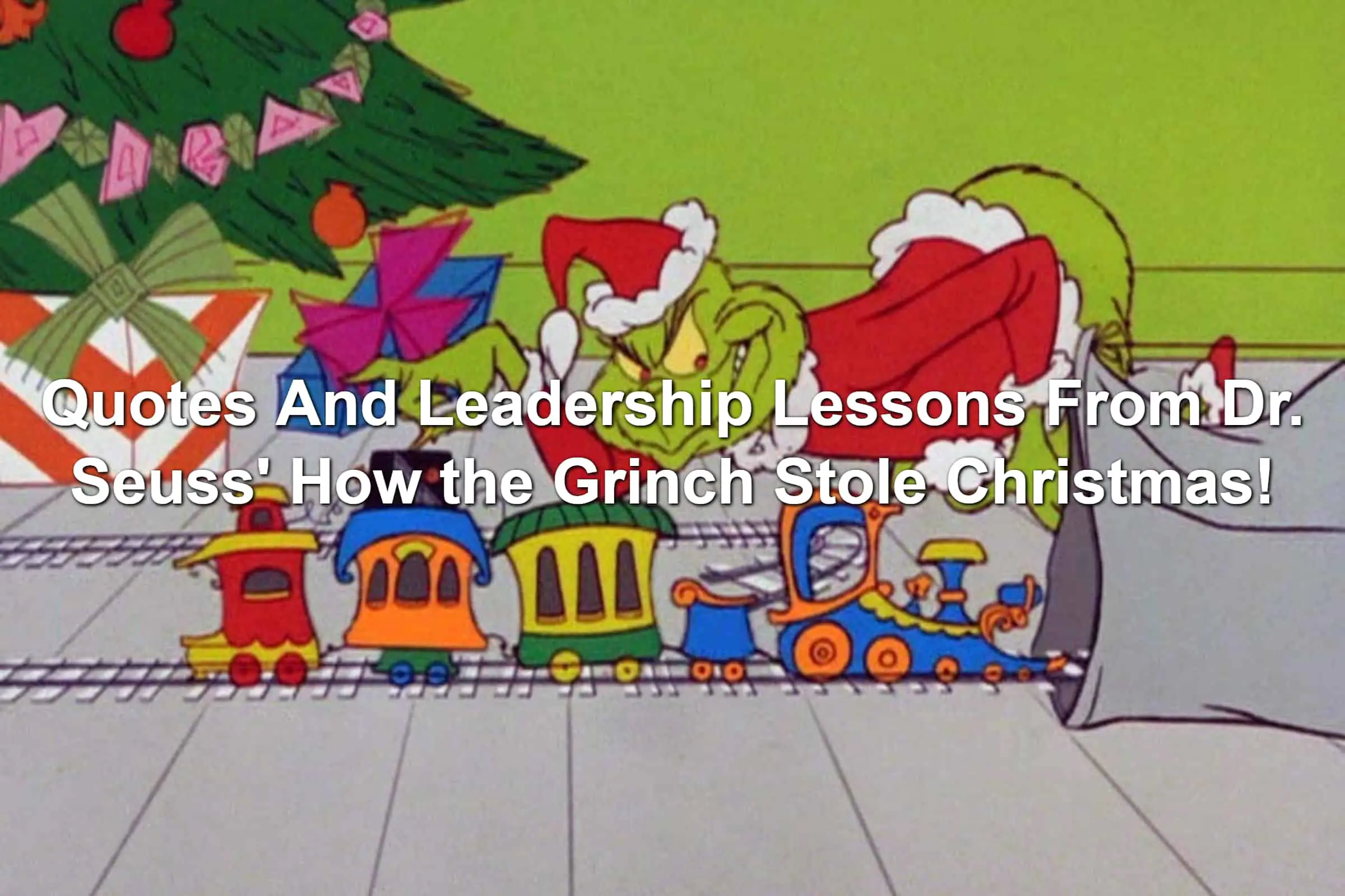 The Grinch in a Santa Claus outfit stealing a toy train set from underneath a tree.