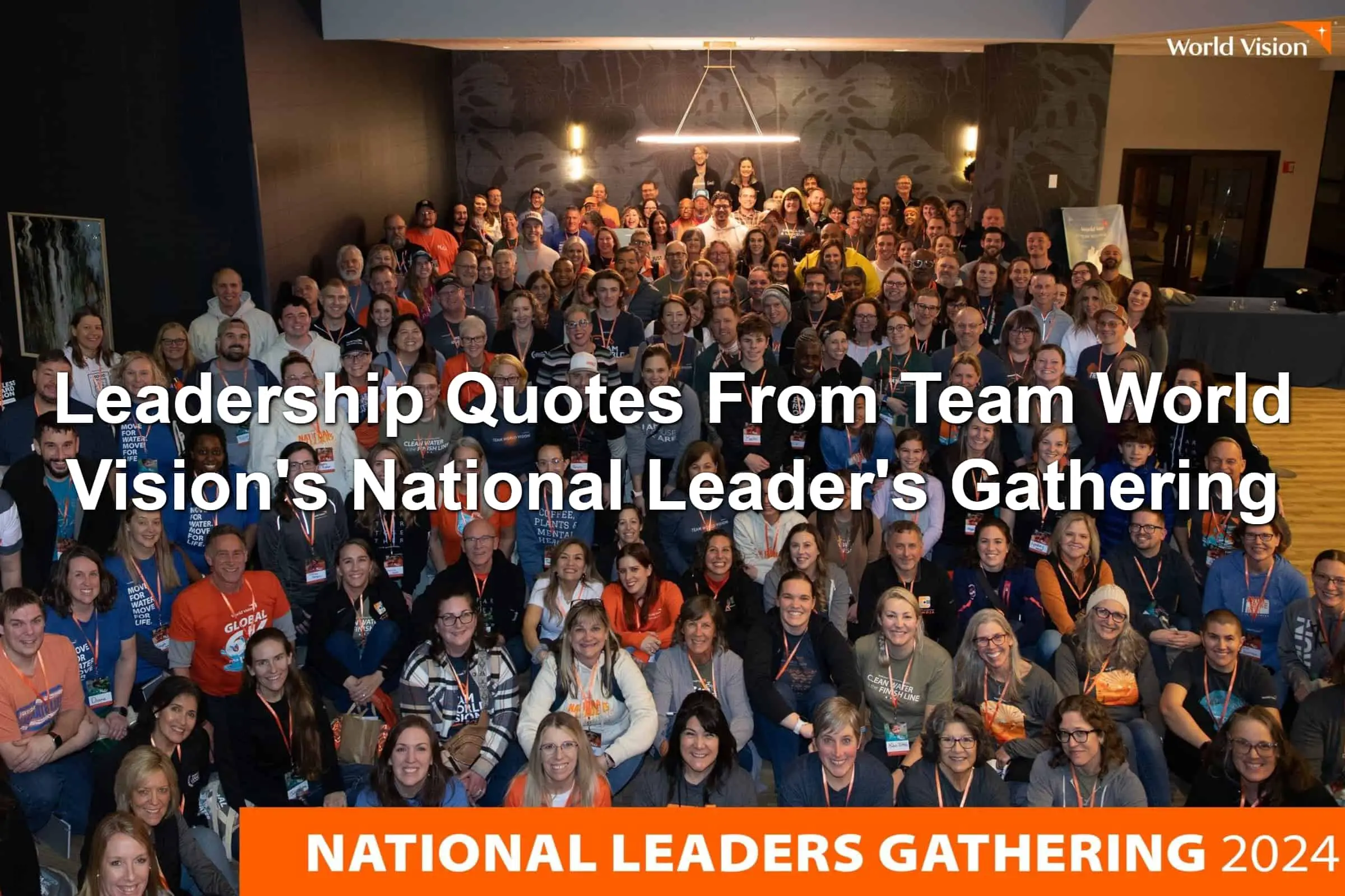 Group photo of people at the Team World Vision National Leader's Gathering 2024. Many in bright orange shirts.